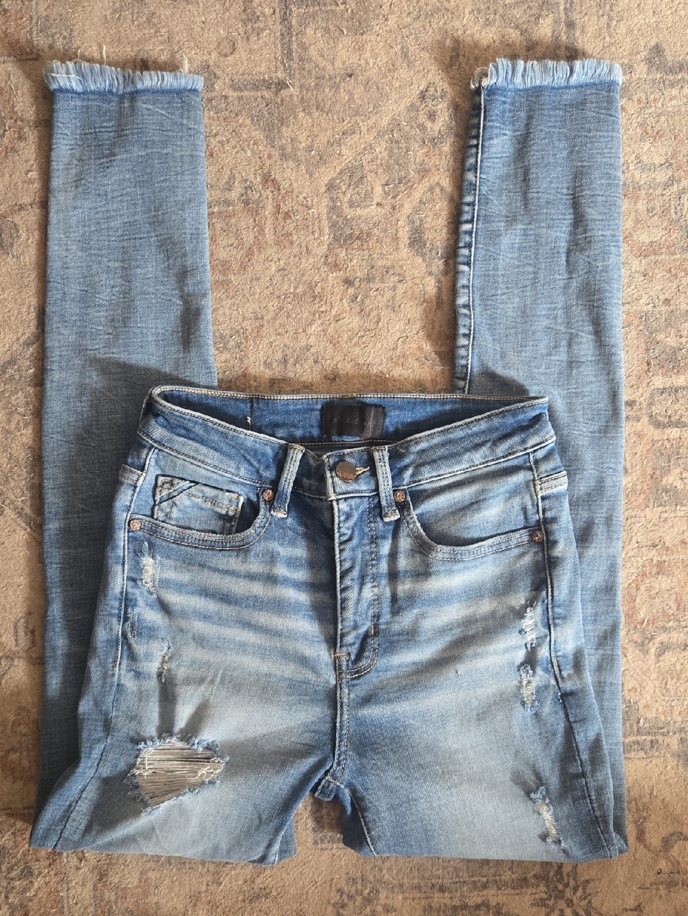 Buckle Light Blue Distressed Skinny Jeans with Frayed Hems